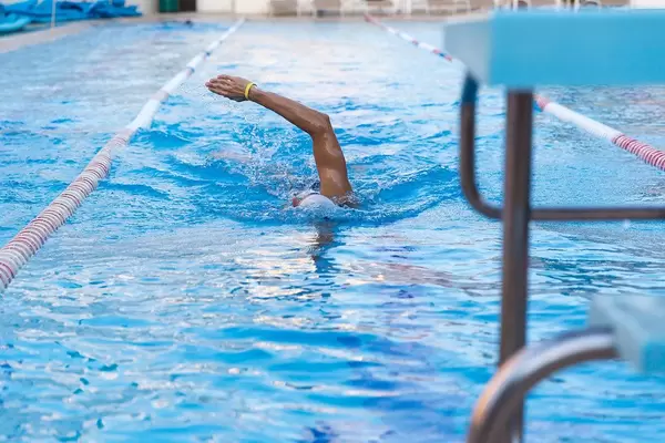 Professional Athlete swimming in an empty pool