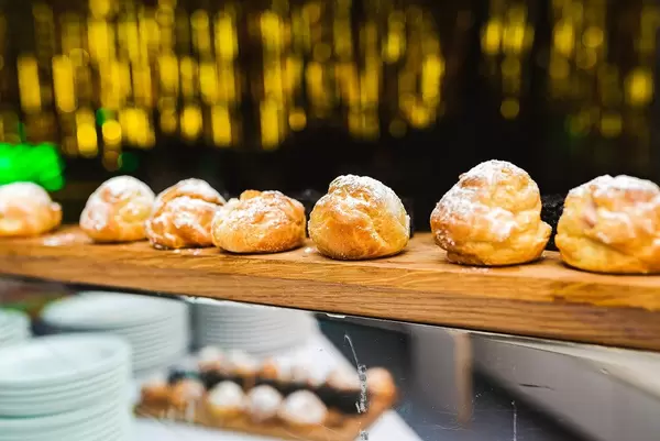 Profiteroles With Boiled Cream With Golden Bokeh Lights Background (Flip 2020)