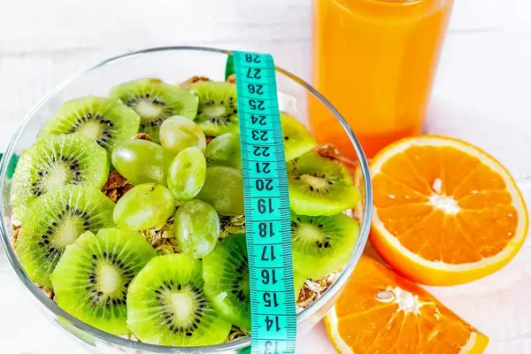 Proper diet for health and a beautiful figure-porridge and orange juice with measuring tape