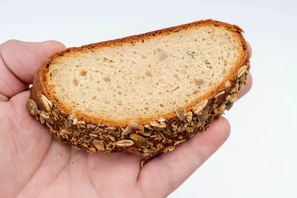 Protein Bread with Pumpkin seed on the hand