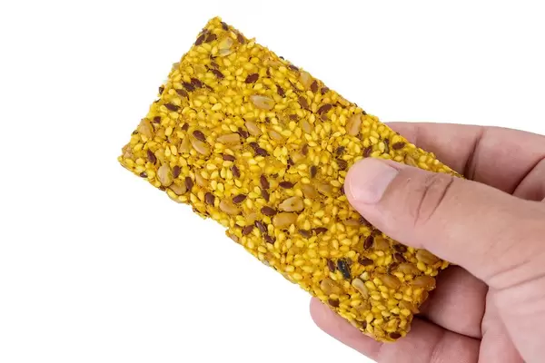 Protein Curcuma Cereals Crackers in the hand (Flip 2019)