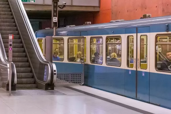 Public transport in Munich, Germany: subway station with train and escalator