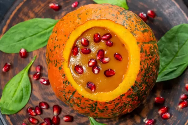 Pumpkin puree with fresh pomegranate seeds and spinach. The view from the top (Flip 2019)