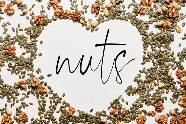 Pumpkin seeds and walnuts layout making heart shape in the center