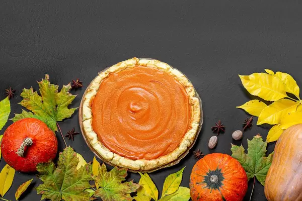Pumpkins with yellow leaves and pumpkin pie. Background for thanksgiving day (Flip 2019)