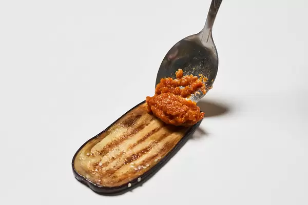 Putting squash caviar on eggplant slice