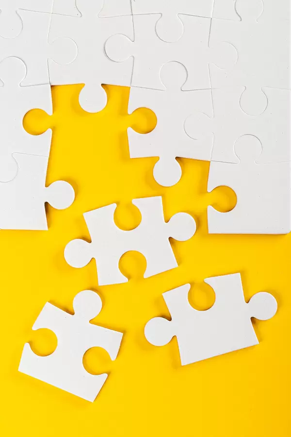Puzzle pieces on yellow background