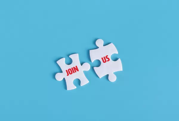 Puzzle pieces with Join Us text