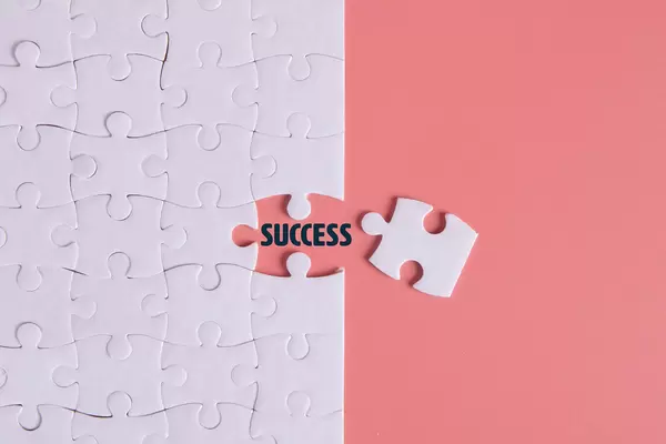 Puzzle pieces with Success text