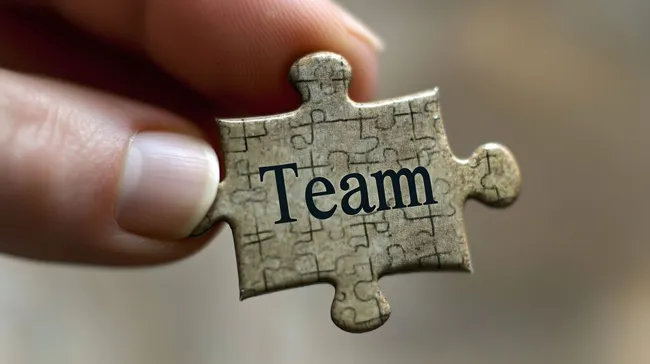 Puzzleteil mit Teamwort - Geschäftskonzept-Stockfoto