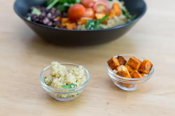 Quinoa und gebratene Süßkartoffeln in kleinen Glasschüsseln