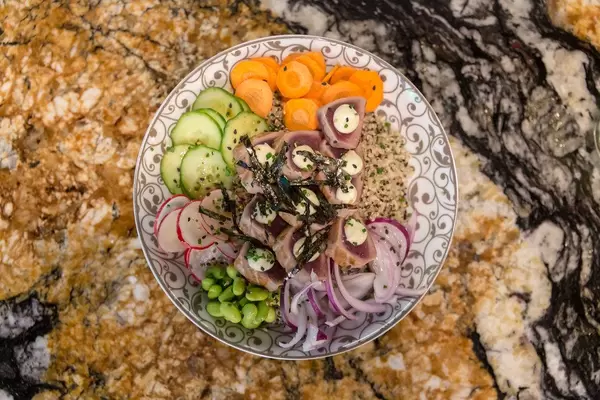 "Tuna Tataki Bowl" at Fit Kitchen in Barcelona, Spain, with marinated Tuna tenderloin pan seared, wasabi, lime soy, avocado cream, Edamame & Nori Sea Weed