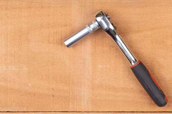 Rachet Tool above wooden table with copy space