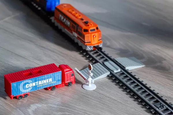 Railway crossing with a truck and a train at the barrier