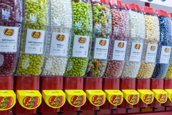 Rainbow candies: large jelly bean dispensers with different flavours on display