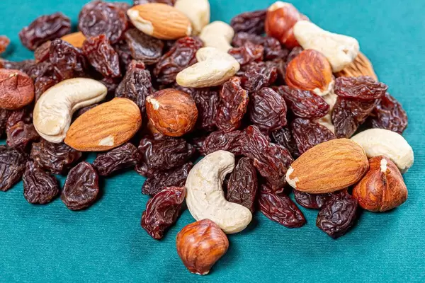 Raisins and different nuts on a green background (Flip 2019)