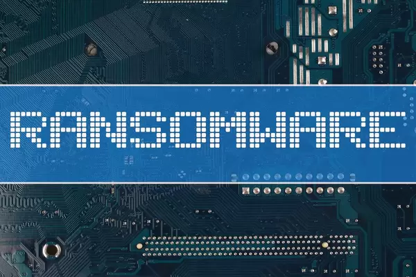 Ransomware text over electronic circuit board background