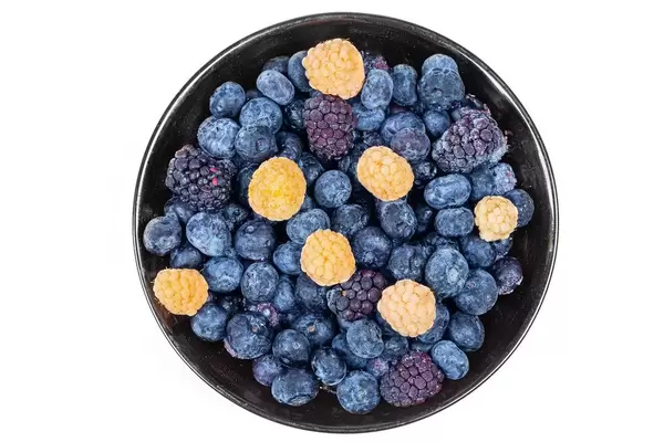 Raspberry, blueberry and mulberry berries in a bowl on a white background, top view (Flip 2020)