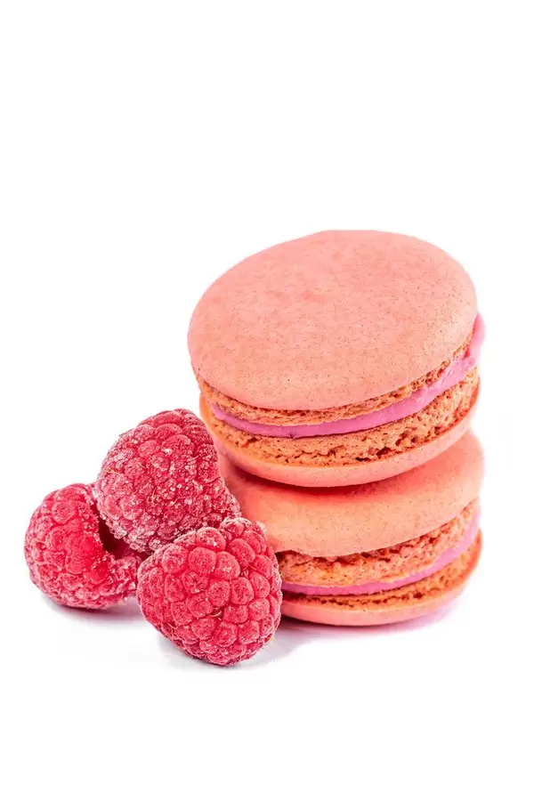 Raspberry macaroon cookies with berries on a white background