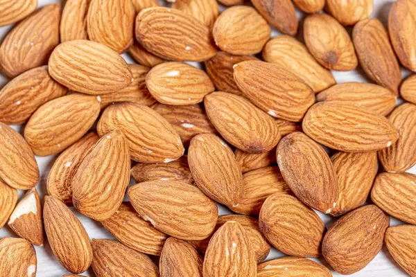 Raw almond nuts background. Top view