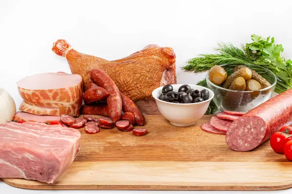 Raw and smoked meat, sausages, vegetables-the concept of the process of cooking solyanka