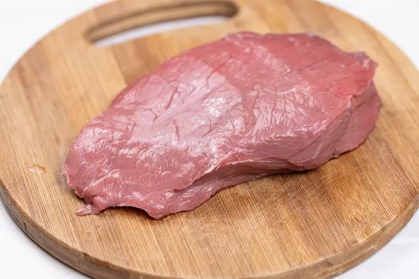 Raw Beef Meat slice on the wooden board