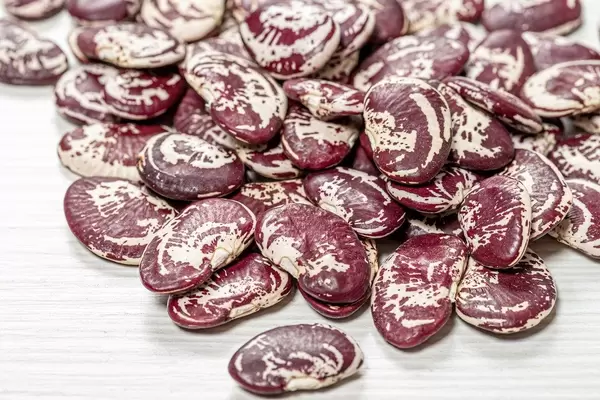 Raw big beans on a white wooden background (Flip 2019)