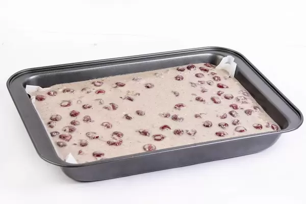 Raw Cake Mixture with cherries ready for baking