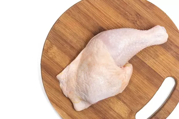 Raw Chicken Drumstics on the wooden board