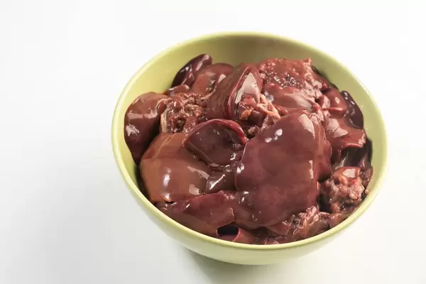 Raw Chicken Liver in the bowl above white background
