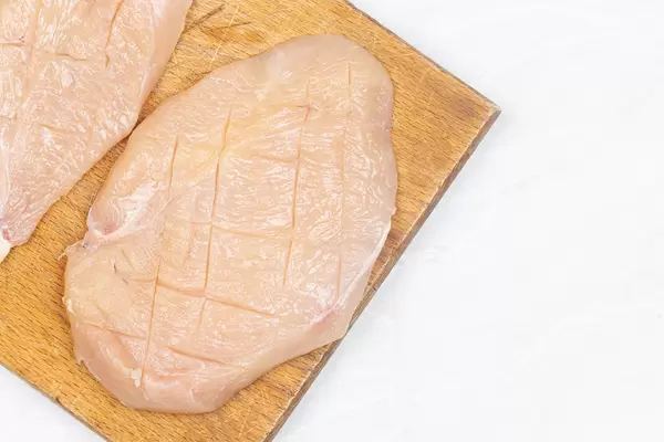 Raw Chicken meat on the wooden board with copy space