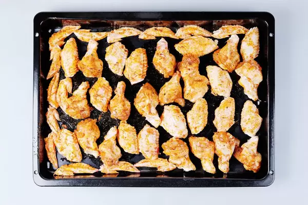 Raw chicken wings in pan, ready to be cooked (Flip 2019)