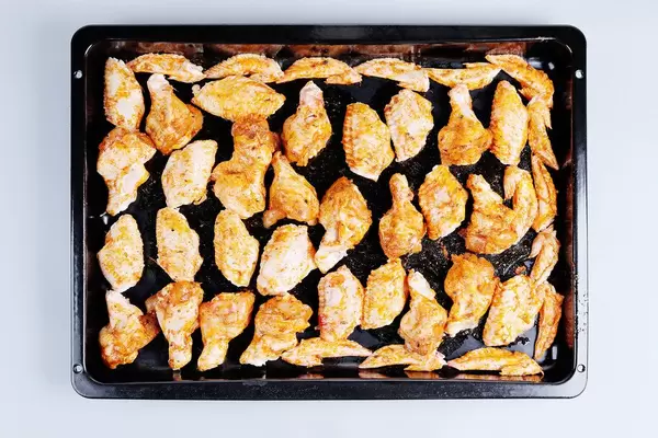 Raw chicken wings in pan, ready to be cooked