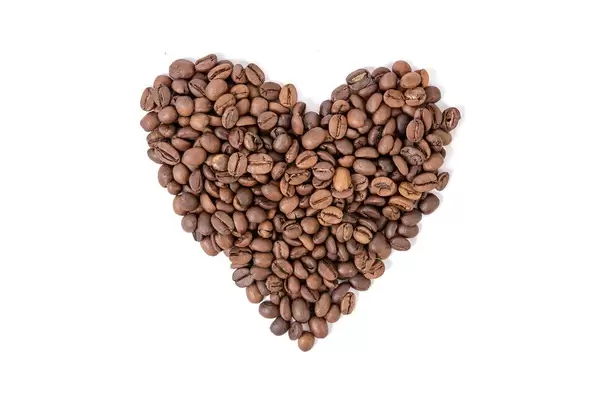 Raw Coffee Heart shape above white background (Flip 2019)