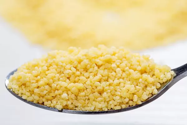 Raw couscous seeds in spoon (Flip 2019)