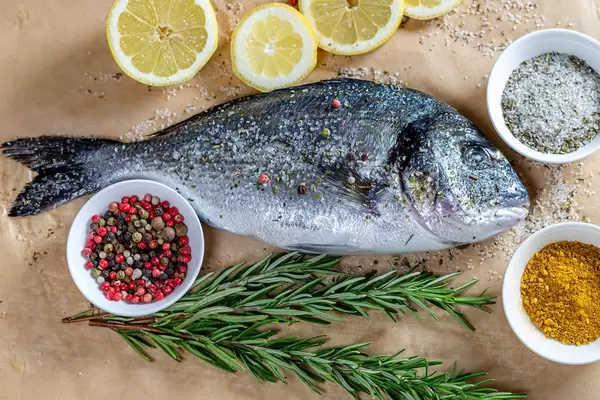 Raw Dorado fish with spices on parchment (Flip 2019)