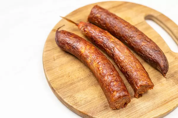 Raw Homemade Pork Meat Sausages on the wooden board