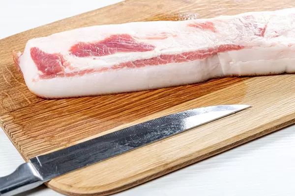 Raw lard with a knife on the kitchen Board (Flip 2019)