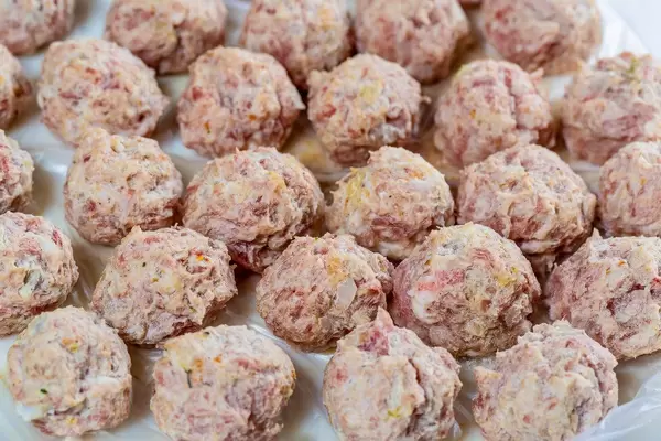 Raw meatballs on white background