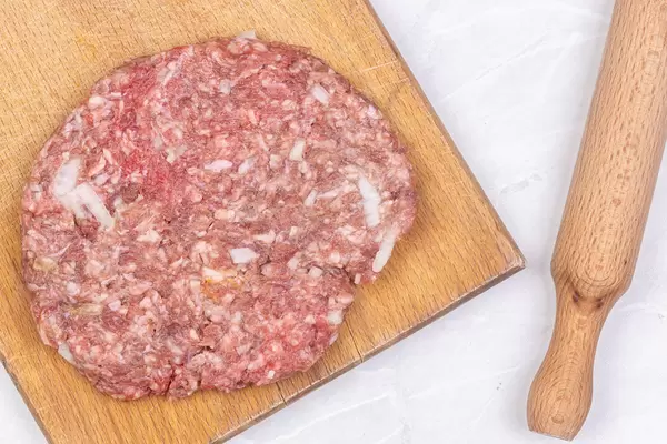 Raw Minced Meat traditional Pljeskavica with chopped onions