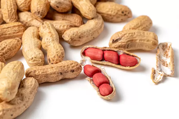 Raw nuts peanuts on white background