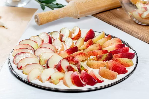 Raw-open-peach-pie-on-a-baking-sheet.jpg