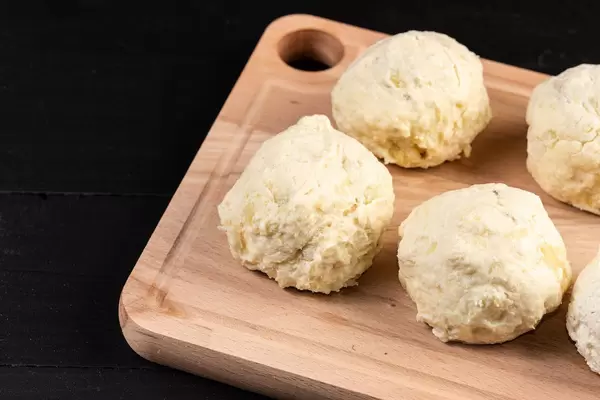 Raw Plum Dumplings above black background