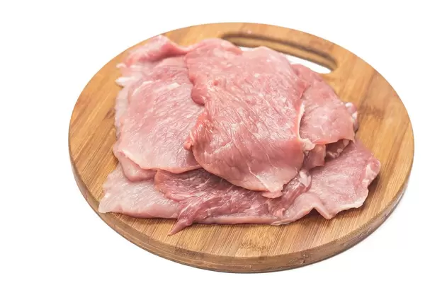 Raw Pork Meat on the wooden board above white background