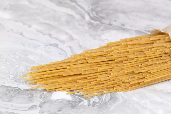 Raw Spaghetti on the grey marble table