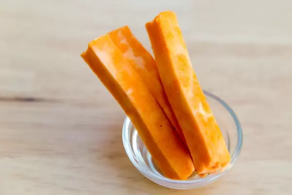 Raw sweet potato stripes in a tiny glass bowl