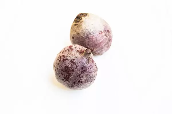 Raw unpeeled beetroot on white background