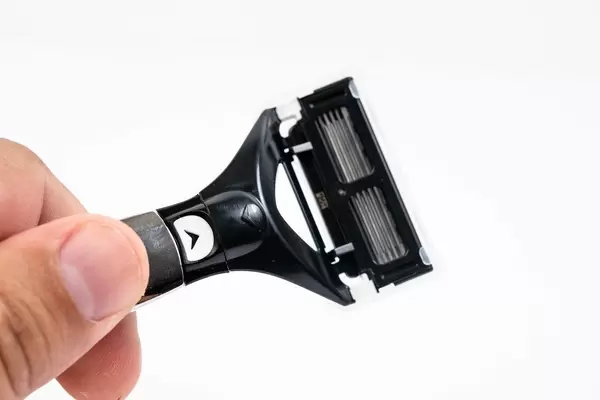 Razor Blade in the hand above white background