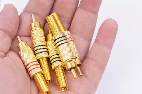 RCA Golden Audio Video Connectors in the hand