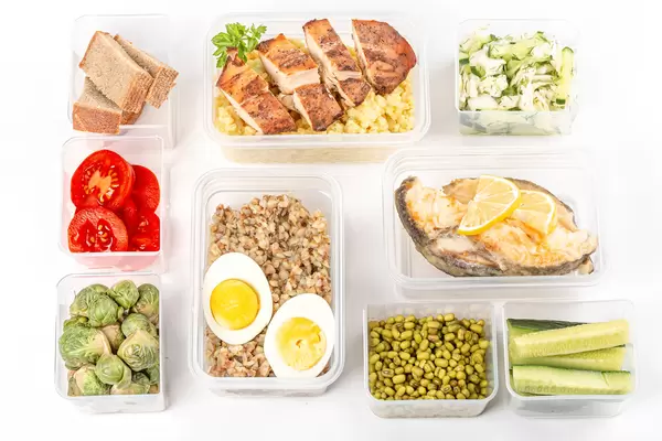Ready healthy food menu in lunch boxes with fish, chicken, porridges and vegetables, top view